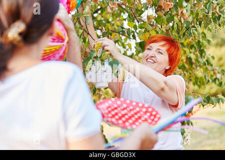 Senior women decorating for a party in their garden Stock Photo