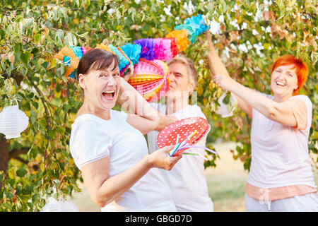Seniors having fun while decorating for a party in a garden Stock Photo