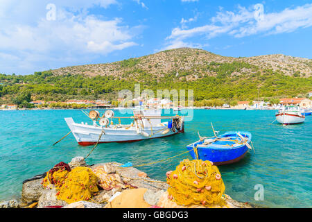 Colorful Greek fishing boats with nets on shore in Posidonio bay, Samos island, Greece Stock Photo