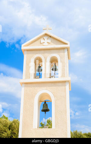 Tower of typical Greek church against blue sky with white clouds in background, Samos island, Greece Stock Photo