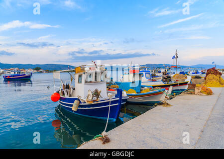 Colourful Greek fishing boats mooring in port at sunset time on Samos island, Greece Stock Photo