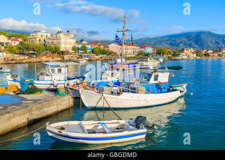 Greek fishing boats mooring in port in sunrise light, Samos island, Greece Stock Photo