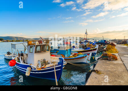Colourful Greek fishing boats mooring in port at sunrise time on Samos island, Greece Stock Photo