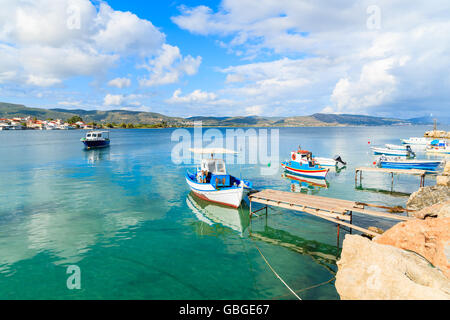 Greek fishing boats on turquoise sea water mooring in port, Samos island, Greece Stock Photo