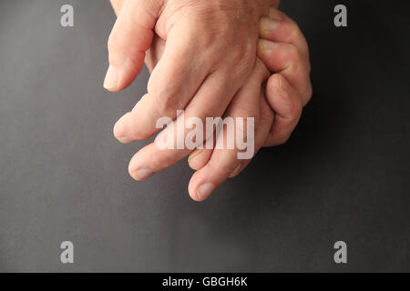 Senior man holding his painful hand Stock Photo