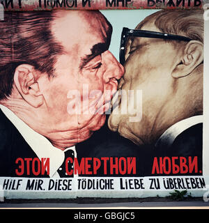 Berlin. Germany. Berlin Wall, The East Side Gallery. Caricature of Leonid Brezhnev & Erich Honecker kissing by artist Dmitri Vrubel.