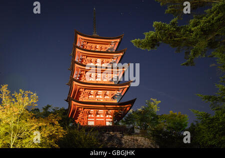 Low Angle View of Japanese Five Story Pagoda and Trees by Night Stock Photo