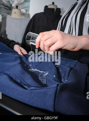Demonstration of Water proof material which has been coated with water repellent  chemical coating Stock Photo