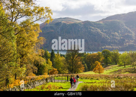 Walkers in the Aira Beck Valley with Ullswater, Sleet Fell and Birk Fell in the distance. Lake District National Park, Cumbria, England. Stock Photo