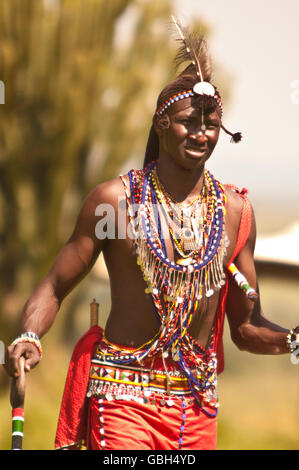 MASAI MARA, KENYA. DECEMBER 18, 2011: A Masai Warrior moves through the African bush. Stock Photo