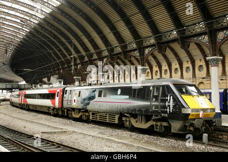 Class 91 loco 91110 'Battle of Britain Memorial Flight' in commemorative livery at York station, UK with Virgin East Coast train Stock Photo