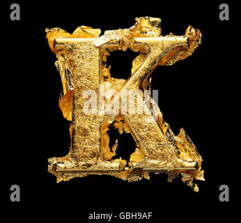 Alphabet and numbers in rough gold leaf isolated on black Stock Photo