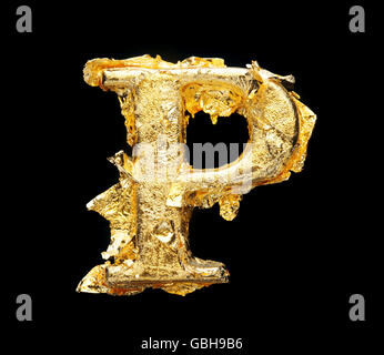 Alphabet and numbers in rough gold leaf isolated on black Stock Photo