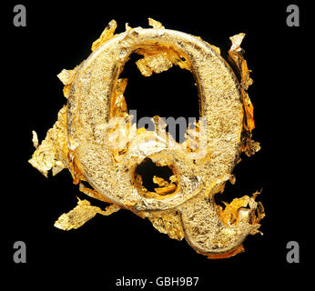 Alphabet and numbers in rough gold leaf isolated on black Stock Photo