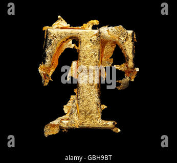 Alphabet and numbers in rough gold leaf isolated on black Stock Photo