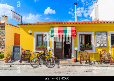 SAMOS ISLAND, GREECE - SEP 24, 2015: bicycle parked in front of Italian restaurant on street of Kokkari town, Samos island, Gree Stock Photo