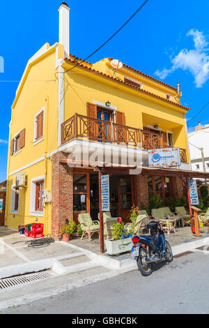 SAMOS ISLAND, GREECE - SEP 24, 2015: motorcycle parked in front of restaurant on street of Kokkari town, Samos island, Greece Stock Photo