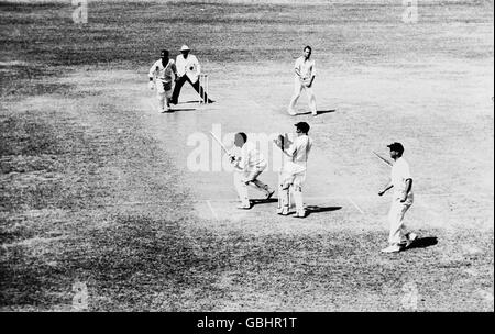 West Indies' Basil Butcher (fourth r) sweeps Australia's Laurie Mayne (top r) for four, watched by Australia wicketkeeper Wally Grout (second r) and teammate Gary Sobers (l) Stock Photo