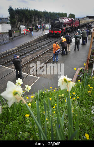 Railway enthusiasts gather to take pictures and gaze at the recently restored LMS 6100 Royal Scot steam engine at Bishop's Lydeard train station on its first day of four days taking part in the West Somerset Railway's Spring steam gala. Stock Photo