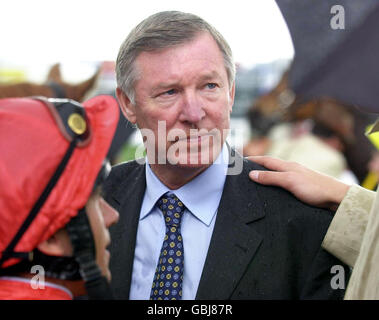 Trainer Ed Dunlop (r, out of pic) pats Sir Alex Ferguson (c) on the shoulder after his horse Candleriggs, ridden by Frankie Dettori (l), was narrowly beaten in the opening race of the day Stock Photo