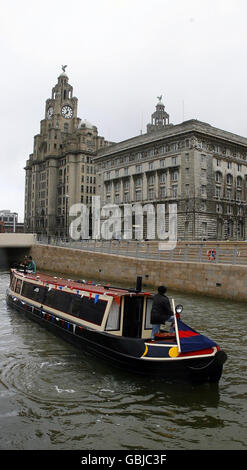 New canal link for Liverpool. Narrow boats pass along a new stretch of canal opened on Liverpool's historic waterfront in Liverpool. Stock Photo