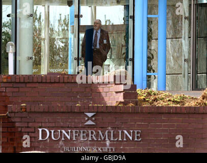 A man looking out of the headquarters of Dunfermline Building Society in Dunfermline. The stricken Building Society has been saved from collapse in a rescue deal with larger mutual Nationwide, the Bank of England announced today. Stock Photo