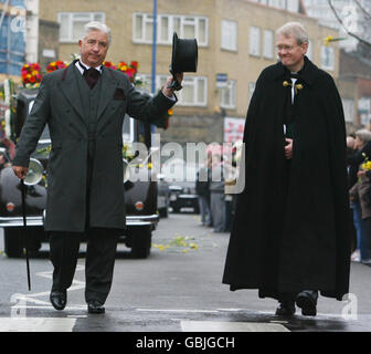 Funeral director Barry Albin-Dyer and the vicar of St Jame's Church, Rev Stewart Hartley, walk ahead of the vintage Rolls-Royce carrying jade Goody's coffin as the funeral procession makes its way through Bermondsey in south-east London, during its journey to St John the Baptist Church in Essex, where the funeral will take place. Stock Photo