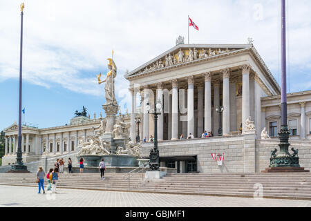 People in front of Austrian parliament building on Ringstrasse in downtown Vienna, Austria Stock Photo