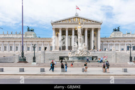 People in front of Austrian parliament building on Ringstrasse in downtown Vienna, Austria Stock Photo