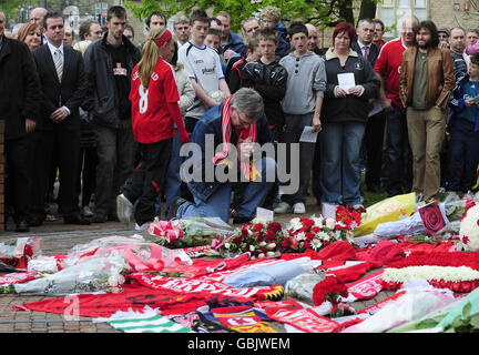 Mourners during a service that was held at the Hillsborough Memorial at the Sheffield Wednesday Football Ground this afternoon when family and friends were able to pay their respects on the 20th Anniversary of the Hillsborough tragedy when 96 Liverpool supporters died at the FA Cup Semi Final against Nottingham Forest at the Sheffield Stadium.The Liverpool fans who died used this entrance to gain access to the ground. Stock Photo
