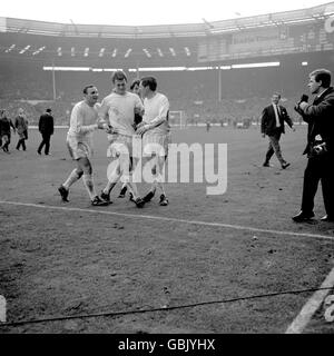 (L-R) Queens Park Rangers' Mark Lazarus, Rodney Marsh, Ian Morgan and Les Allen leave the pitch after their incredible 3-2 victory Stock Photo