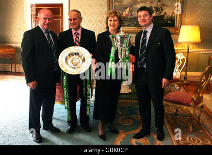 Irish rugby coach Declan Kidney (left) and captain Brian O'Driscoll (right) chat with President Mary McAleese and her husband Martin during a state reception for the Grand slam winning team at Aras an Uachtarain in Dublin. Stock Photo