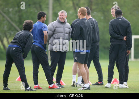 Manchester United manager Sir Alex Ferguson (center) during a training session at Carrington Training Ground, Manchester. Stock Photo