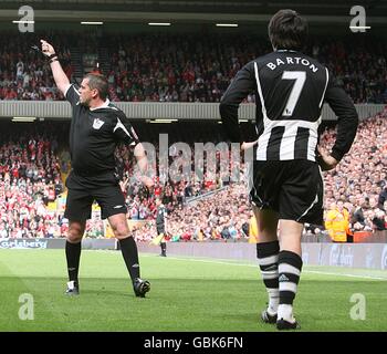 Referee Phil Dowd (left) directs Newcastle United's Joey Barton (right) off the pitch after showing him the red card. Stock Photo