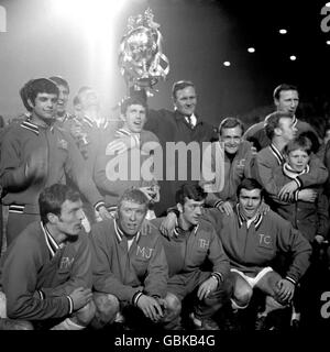 Leeds United celebrate with the League Championship trophy after the match: (back row, l-r) Mick Bates, Rod Belfit, Paul Reaney, Johnny Giles, manager Don Revie, trainer Les Cocker, Billy Bremner, Jack Charlton; (front row, l-r) Paul Madeley, Mick Jones, Terry Hibbitt, Terry Cooper Stock Photo