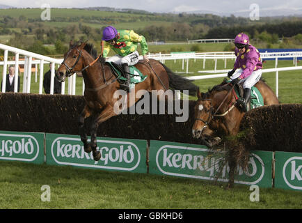 Big Zeb ridden by Barry Geraghty (right) hits the final fence allowing Master Minded and Ruby Walsh (left) to win the Kerrygold Champion Chase during the Punchestown Racing Festival at Punchestown Racecourse, Ireland. Stock Photo