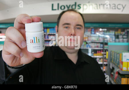 Tony mullins holds a pack of alli at lloydspharmacy hi res stock