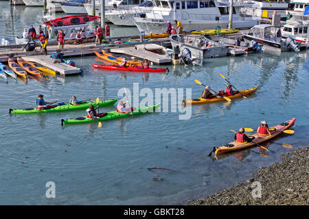 Kayakers, wearing safety gear departing Port of Valdez. Stock Photo