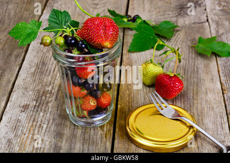Strawberry, Black Currant and Tea on Wooden Rustic Background Stock Photo