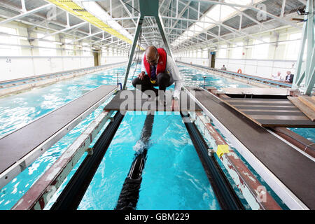 Project Engineer Uspal Thind checks on the Anaconda wave energy converter as it is tested at QinetiQ test tank in Gosport, Hampshire. Stock Photo