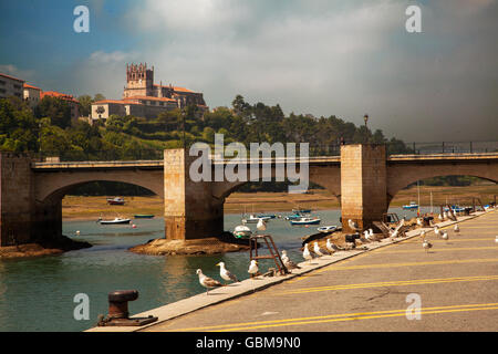 View from the harbour towards the hill top church in San Vicente de la Barquera Northern Spain Stock Photo