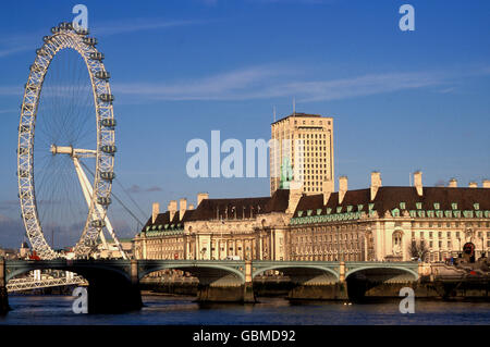 The London Eye, a giant Ferris wheel on  with  County Hall, south bank of River Thames, LOndon, UK Stock Photo