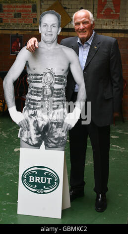 Sir Henry Cooper is photographed beside a cardboard cut-out of him wearing his three Lonsdale belts representing British and Empire heavyweight championships on January 16, 1968 during a media Photocall at Repton Boys Club, London. Stock Photo