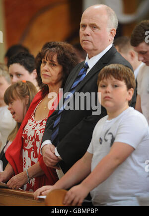 Margaret and Barry Mizen, parents of murdered schoolboy Jimmy Mizen, with son George, during a memorial service to mark the first anniversary of Jimmy's death, held at the Our Lady of Lourdes Church in London. Stock Photo