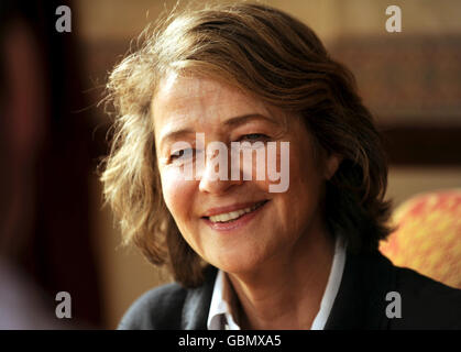 Actress Charlotte Rampling speaks to the media as her father Godfrey Rampling who is Britain's oldest Olympian celebrates his 100th Birthday during a party at Bushey House, Bushey. Stock Photo