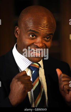 Kriss Akabusi speaks to the media during a party to celebrate the 100th Birthday of Britain's oldest Olympian Godfrey Rampling at Bushey House, Bushey. Stock Photo