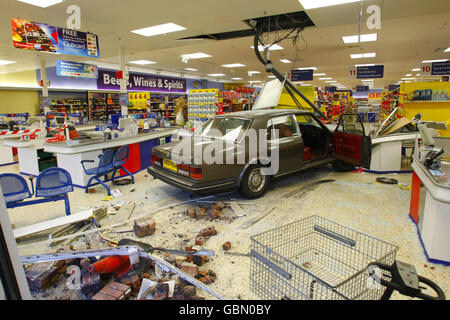 A Rolls Royce car after it smashed through the window of the Tesco superstore in Andover, Hampshire. A 50 year old man was arrested on suspicion of attempted murder and drink-driving today after a Rolls Royce crashed into the supermarket. Six women suffered cuts, bruising and shock when the vehicle went through the window of the Tesco store in River Way, Andover, Hampshire, at about 4.30 this afternoon, police said. Shoppers ran for cover as the car smashed into shelves and tills and then tried to reverse out but got stuck. Stock Photo