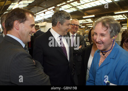 Prime Minister Gordon Brown (centre) with Robert Bleese (right), who has worked at the company for 50 years during his visit to the glazing firm Percy Lane Products in Tamworth, West Midlands. Stock Photo