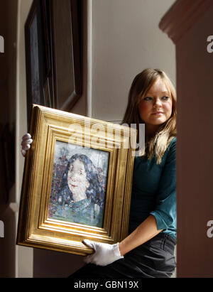 Heidi Squirrell from Lyon & Turnbull holds a rare painting by artist John Pringle, estimated to sell for between 35,000 and 45,000 at the Lyon & Turnbull auction house in Edinburgh. Stock Photo