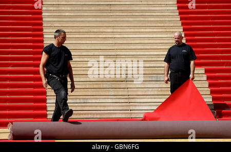 Workers prepare the red carpet on the steps of the Palais des Festivals, in Cannes, France, ahead of the start of the Festival de Cannes. Stock Photo